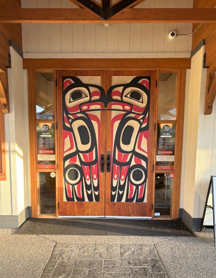 Red and black Indiginous art carved into two large doors